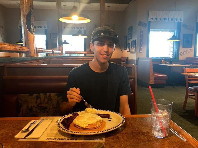 eating eggs on top of pancakes